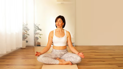 Woman practicing yoga for PCOS at home